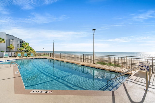 view of pool featuring a water view