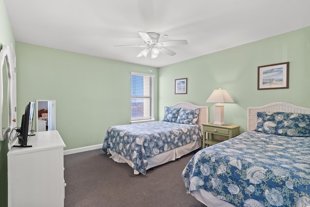 bedroom with dark colored carpet and ceiling fan