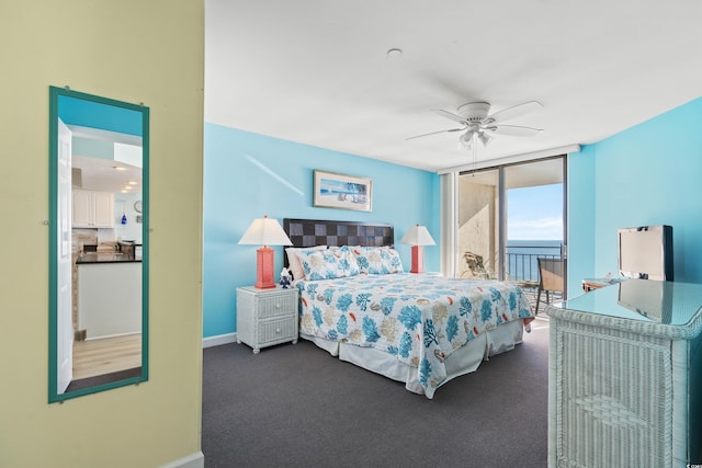 carpeted bedroom with floor to ceiling windows and ceiling fan