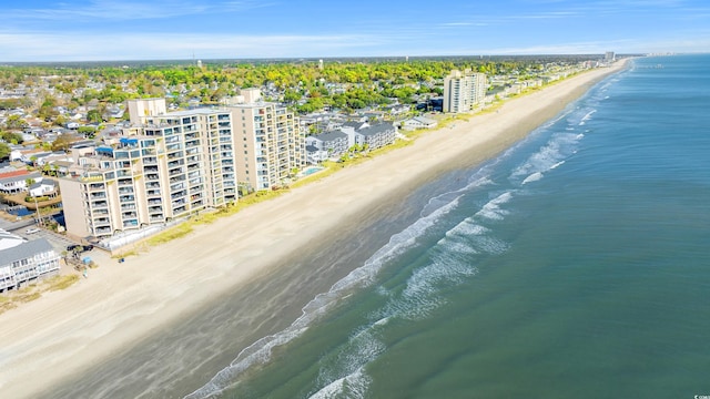 drone / aerial view with a water view and a beach view