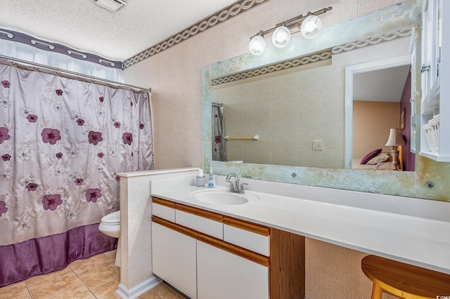 full bathroom featuring tile patterned flooring, vanity, shower / tub combo, toilet, and a textured ceiling