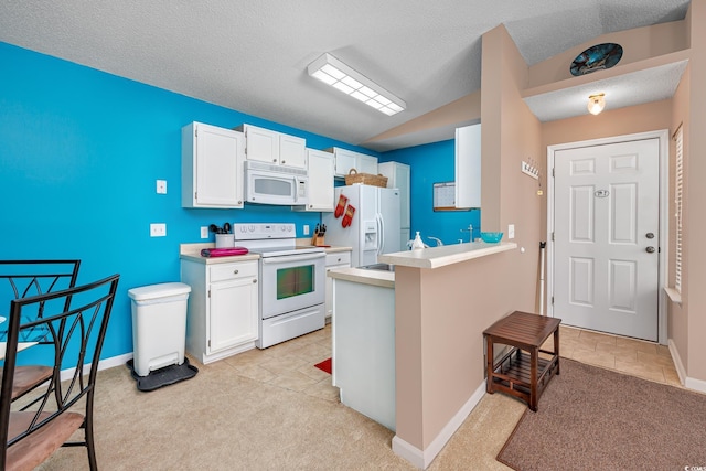 kitchen with white appliances, white cabinets, a textured ceiling, light colored carpet, and kitchen peninsula