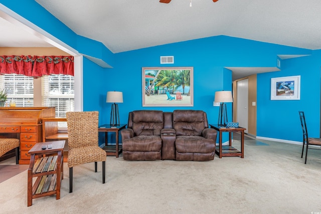 carpeted living room featuring vaulted ceiling and ceiling fan