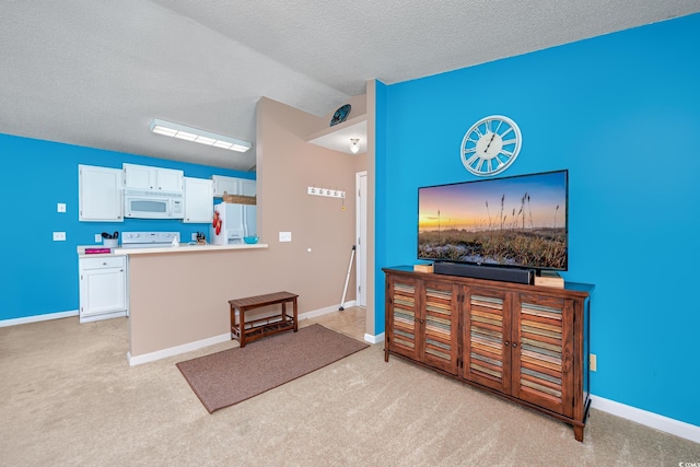 interior space featuring white cabinetry, vaulted ceiling, light carpet, a textured ceiling, and white appliances