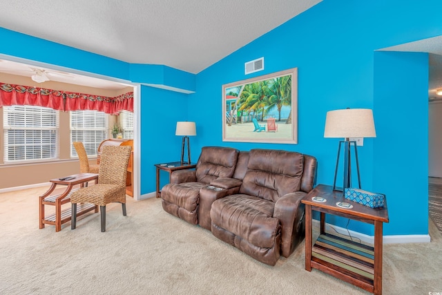 living room featuring carpet floors, vaulted ceiling, and a textured ceiling