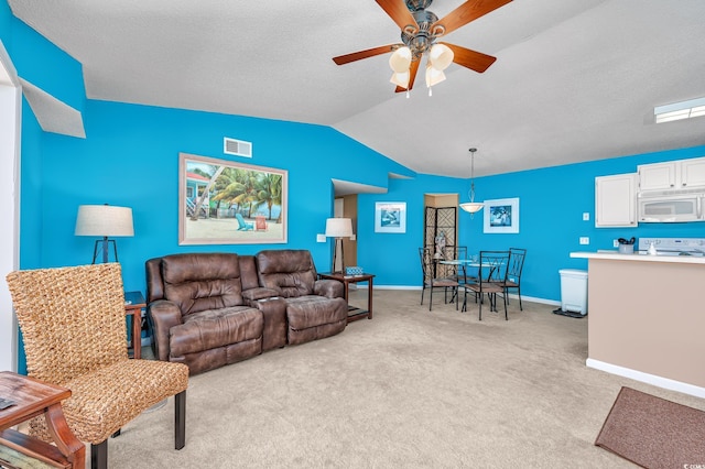 living room featuring ceiling fan, light colored carpet, lofted ceiling, and a textured ceiling