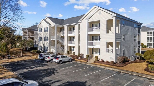 901 W Port Dr Unit 1706, North Myrtle Beach, SC 29582 - view of building exterior with uncovered parking and central air condition unit