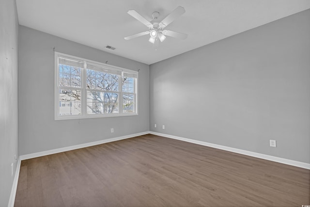 901 W Port Dr Unit 1706, North Myrtle Beach, SC 29582 - empty room featuring dark wood finished floors, visible vents, and baseboards