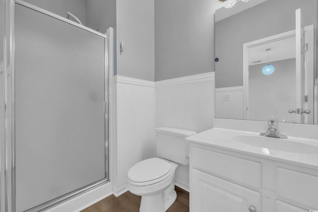 901 W Port Dr Unit 1706, North Myrtle Beach, SC 29582 - bathroom featuring a stall shower, wainscoting, toilet, and wood finished floors