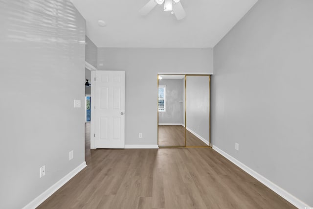 901 W Port Dr Unit 1706, North Myrtle Beach, SC 29582 - unfurnished bedroom with a closet, baseboards, a ceiling fan, and wood finished floors