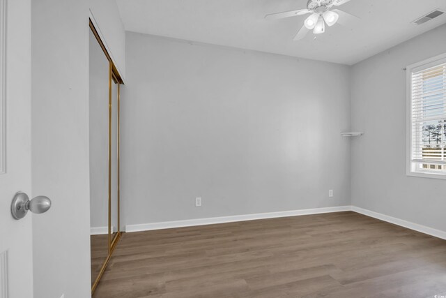 901 W Port Dr Unit 1706, North Myrtle Beach, SC 29582 - unfurnished bedroom with a closet, wood finished floors, visible vents, ceiling fan, and baseboards