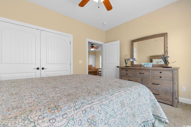 carpeted bedroom with ceiling fan and a closet