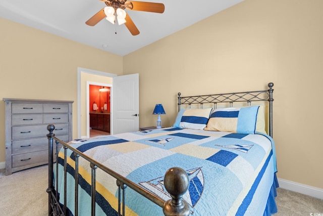 bedroom featuring ceiling fan, ensuite bathroom, and light carpet