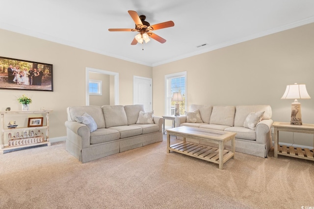 carpeted living room with ceiling fan and ornamental molding