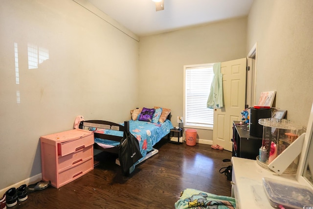 bedroom with baseboards, dark wood-style flooring, and ceiling fan