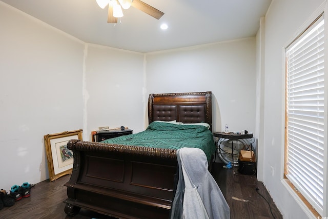 bedroom featuring multiple windows, dark wood-type flooring, and ceiling fan