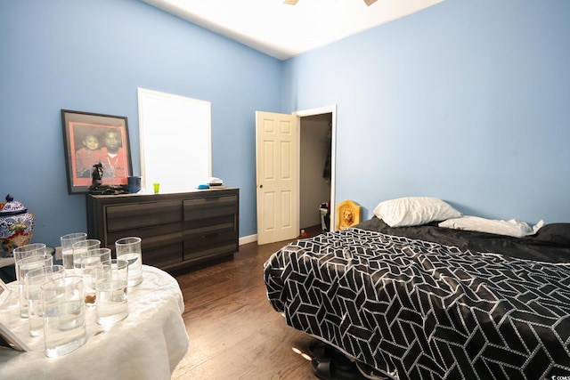 bedroom featuring ceiling fan, baseboards, and wood finished floors