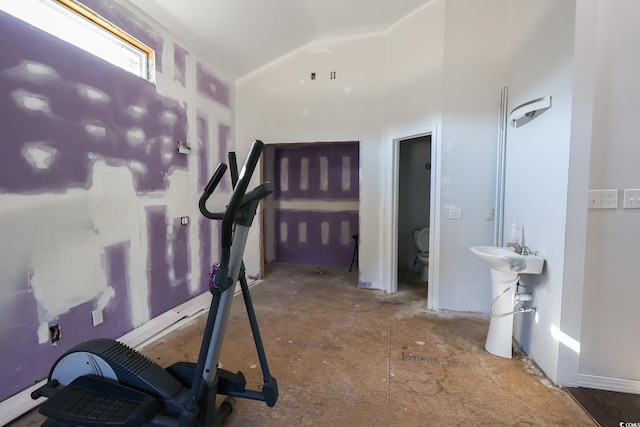 workout room with vaulted ceiling