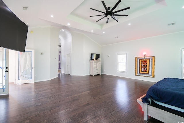 bedroom featuring visible vents, a raised ceiling, and wood finished floors