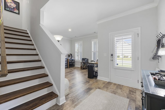 foyer featuring plenty of natural light, light hardwood / wood-style floors, and crown molding