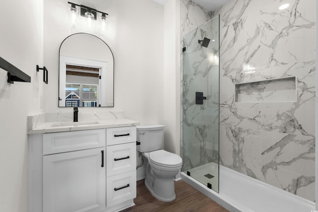 7053 Byrnes Ln, Myrtle Beach, SC 29588 - bathroom featuring wood finished floors, toilet, vanity, and a marble finish shower