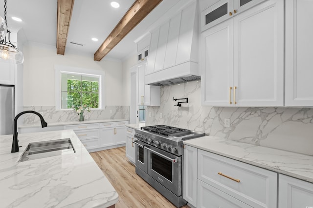 7053 Byrnes Ln, Myrtle Beach, SC 29588 - kitchen featuring beamed ceiling, a sink, custom exhaust hood, white cabinets, and appliances with stainless steel finishes