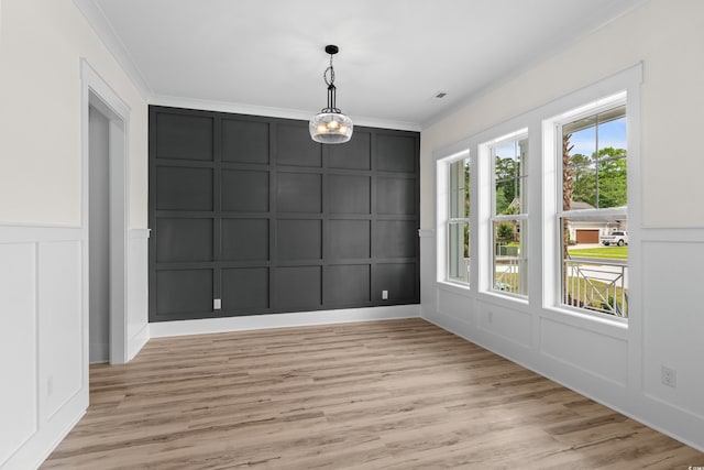 7053 Byrnes Ln, Myrtle Beach, SC 29588 - unfurnished dining area with a decorative wall, light wood-type flooring, and crown molding