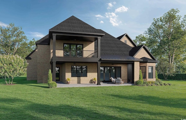 rear view of property with a lawn, a balcony, ceiling fan, a patio area, and brick siding