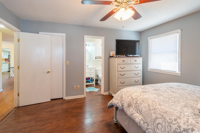 bedroom featuring ceiling fan, ensuite bathroom, dark hardwood / wood-style flooring, and a textured ceiling