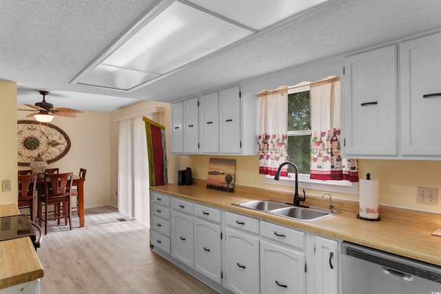 1020 Thomas Ave, North Myrtle Beach, SC 29582 - kitchen featuring stainless steel dishwasher, a sink, white cabinets, ceiling fan, and light wood-type flooring