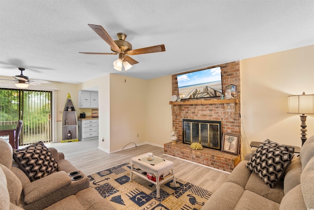 1020 Thomas Ave, North Myrtle Beach, SC 29582 - living room featuring ceiling fan, light wood-style flooring, a brick fireplace, and baseboards