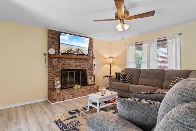 1020 Thomas Ave, North Myrtle Beach, SC 29582 - living area with wood finished floors, a ceiling fan, baseboards, and a brick fireplace