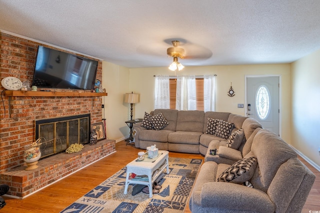 living room featuring hardwood / wood-style floors, a fireplace, and a textured ceiling