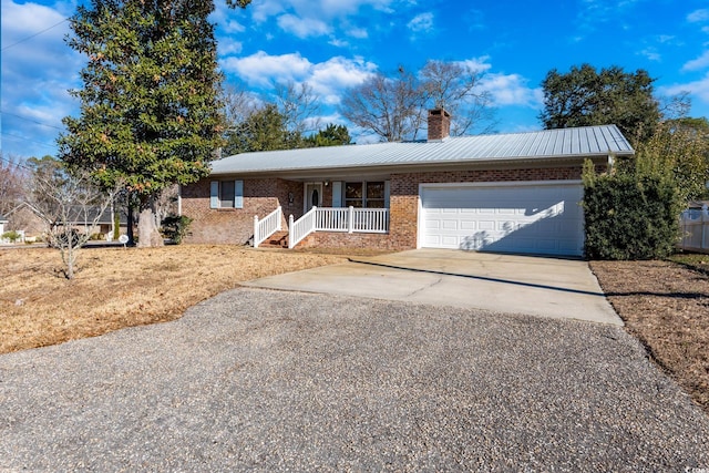 ranch-style house with a porch and a garage