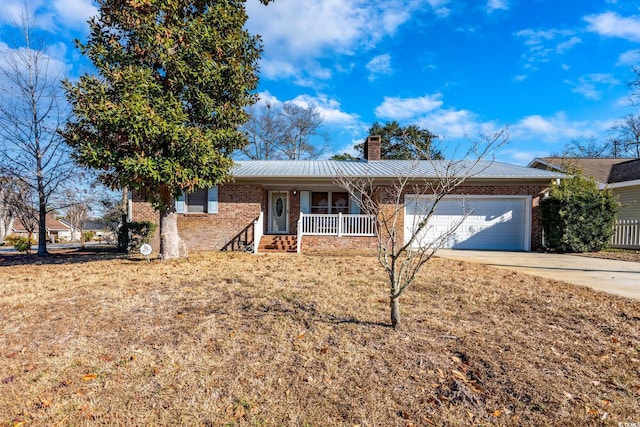 single story home featuring a garage, a front lawn, and covered porch