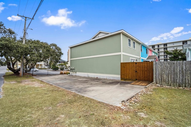 view of side of home with a lawn