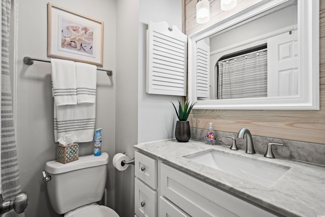 bathroom featuring toilet and vanity