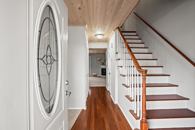 interior space with hardwood / wood-style flooring, ornamental molding, and wood ceiling