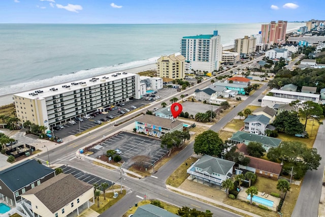 birds eye view of property with a beach view and a water view