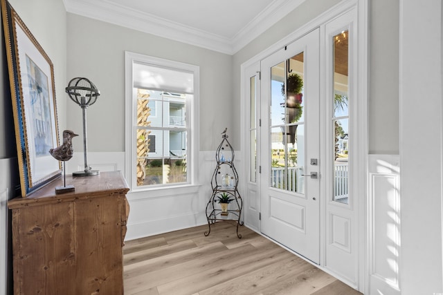 doorway featuring ornamental molding and light hardwood / wood-style floors