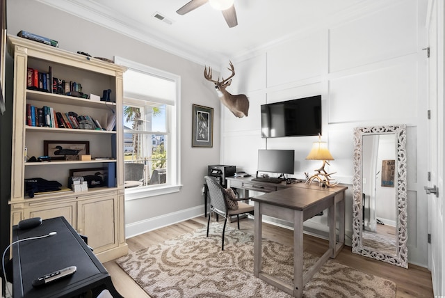 office space featuring ornamental molding, light hardwood / wood-style floors, and ceiling fan