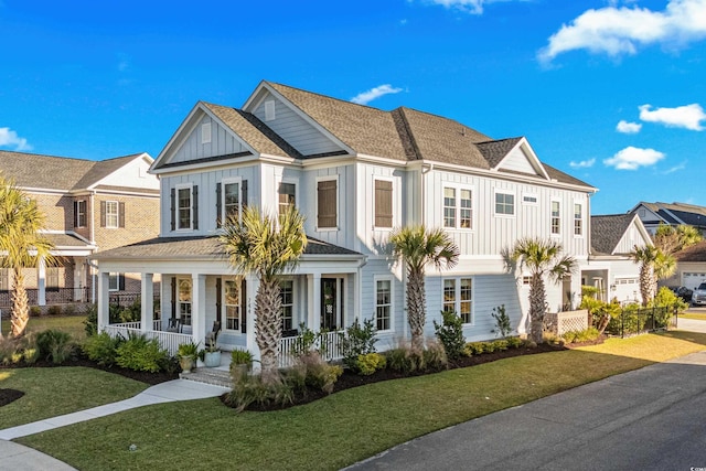 view of front of house with a porch, a garage, and a front yard