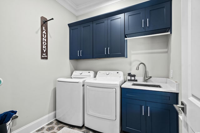 washroom with cabinets, ornamental molding, sink, and washing machine and dryer