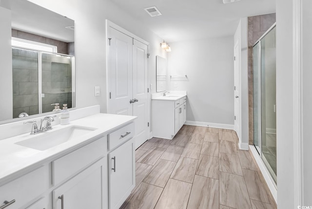 bathroom featuring vanity and a shower with door