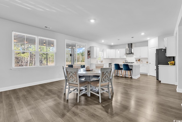 dining space featuring dark wood-type flooring