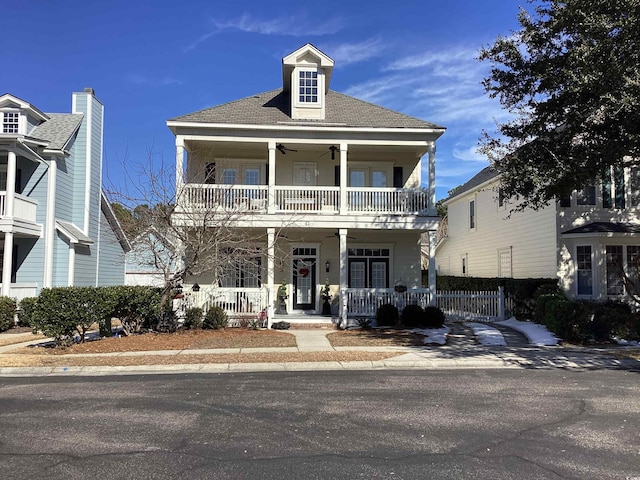 view of front of property with ceiling fan, a balcony, and covered porch