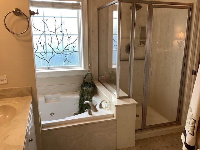 bathroom featuring independent shower and bath, vanity, and tile patterned floors