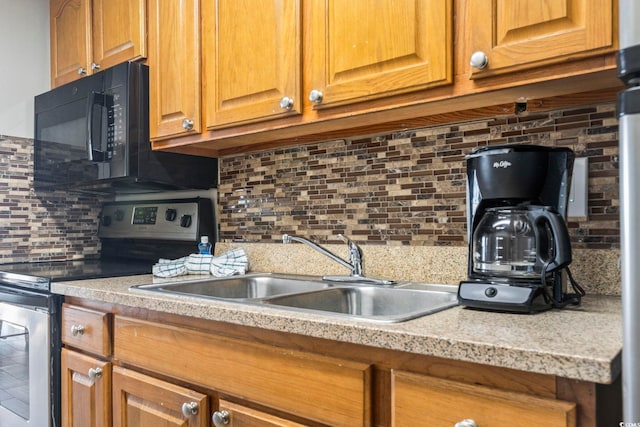 kitchen featuring tasteful backsplash, sink, and electric range