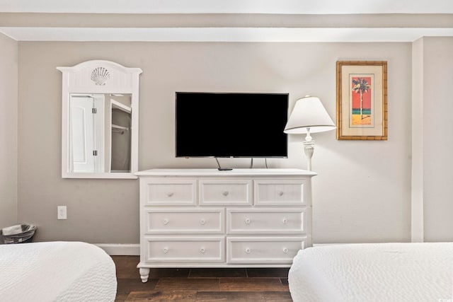 bedroom with dark hardwood / wood-style floors