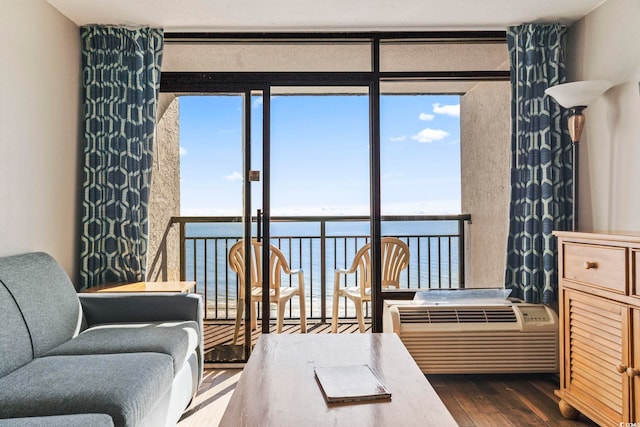 interior space with a water view, floor to ceiling windows, and dark wood-type flooring